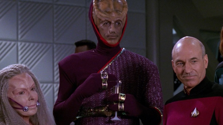 Leyor standing in between Captain Picard and another alien diplomat on Star Trek: The Next Generation.