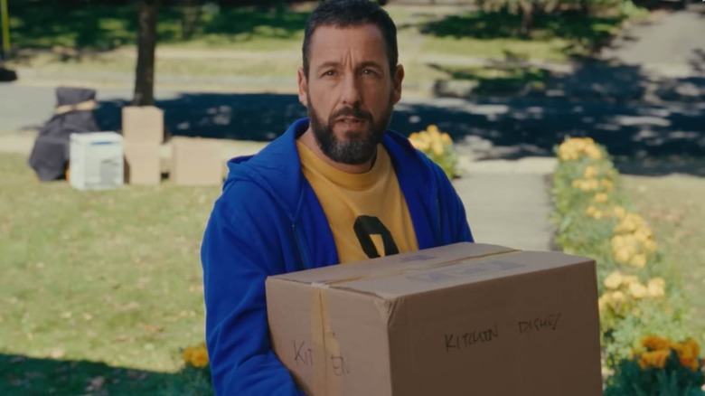 Happy Gilmore holding a box