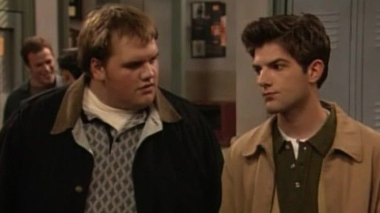 Frankie questioningly looks at the stoic Griff Hawkins in Boy Meets World