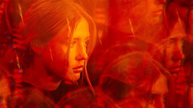 Adèle Exarchopoulos in a prism lens lit in red from the film the five devils