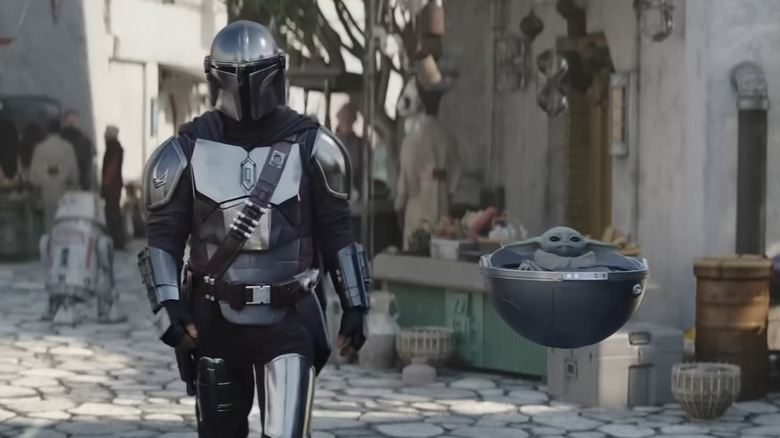 Grogu and Pedro Pascal in The Mandalorian season 3