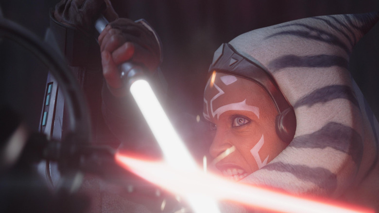 Rosario Dawson as Ahsoka locked in a lightsaber duel with an Inquisitor in Ahsoka