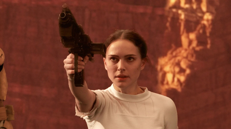 Natalie Portman as Padme Amidala, holding a gun, in Star Wars: Attack of the Clones