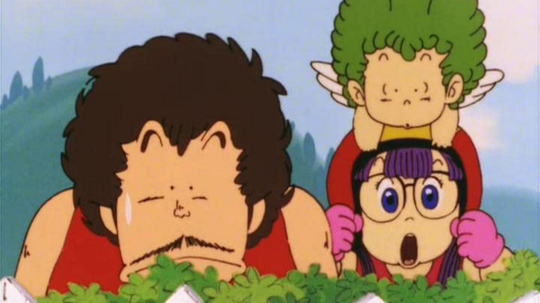 Dr. Slump Senbei Arale and Gatchan watch behind fence