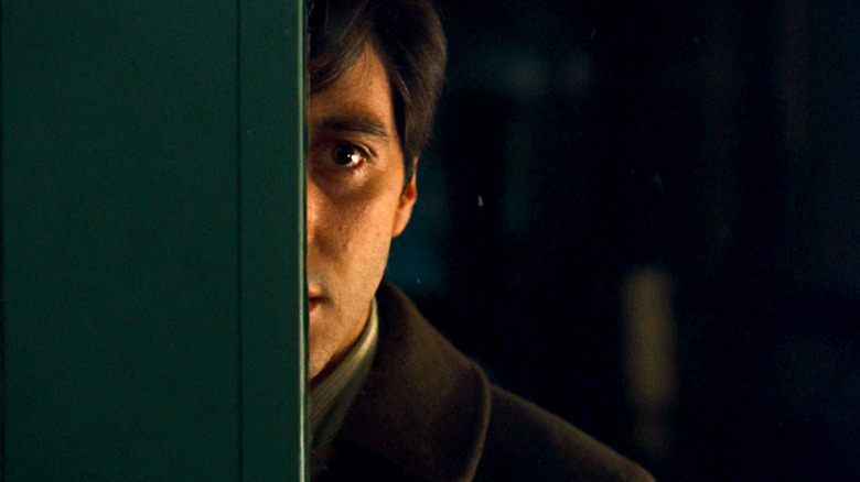 Al Pacino hides behind a doorway in The Godfather