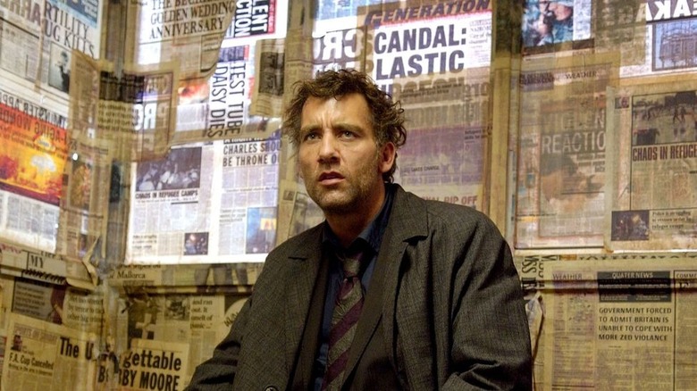 Children of Men Clive Owen newspapers on wall