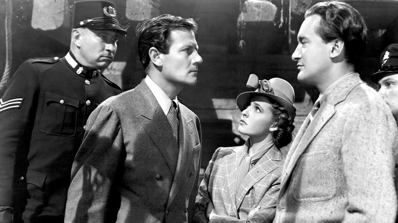 Joel McCrea glares at Laraine Day and George Sanders in Foreign Correspondent