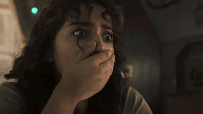 Isabela Merced's Kay with her hand over her mouth in fear in Alien: Romulus