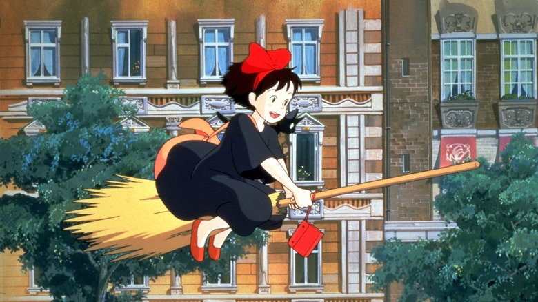 Kiki and Jiji joyously fly a broom through town in Kiki's Delivery Service