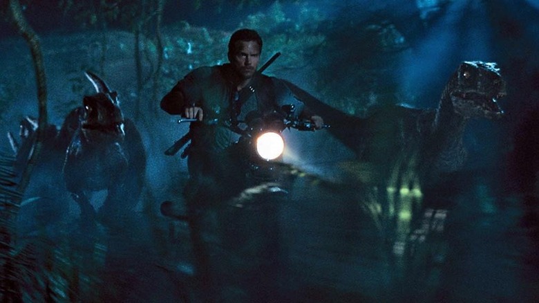 Chris Pratt's Owen Grady riding his motorcylce alongside the raptors in Jurassic World