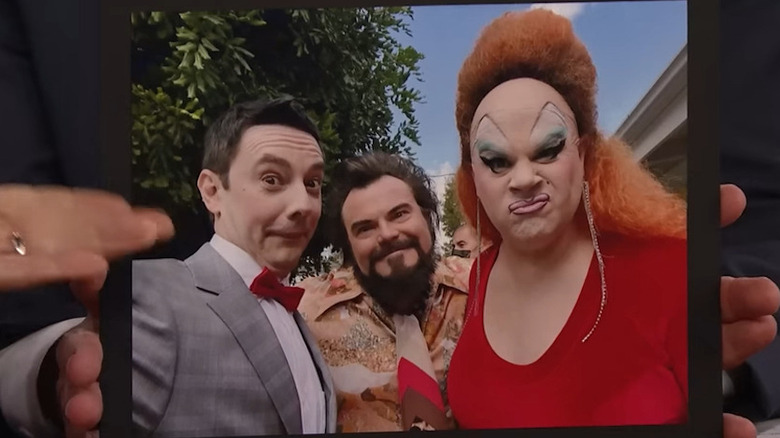 Jorma Taccone showing a pic of himself as Pee-Wee Herman, Jack Black as Wolfman Jack, and Nina West as Divine in Weird: The Al Yankovic Story