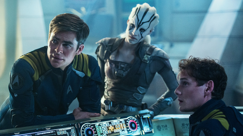 Kirk, Jaylah, and Chekov gathered around the control console in Star Trek Beyond