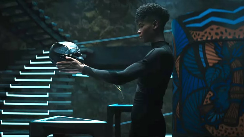 Shuri holds a new Black Panther helmet in Wakanda Forever