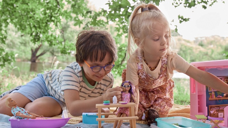 Children playing with Barbie