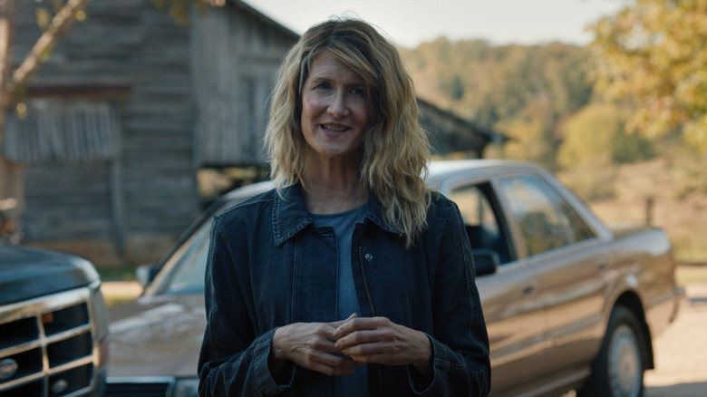 Laura Dern's Elizabeth Gilbert stands in front of some cars and a barn in Trial by Fire