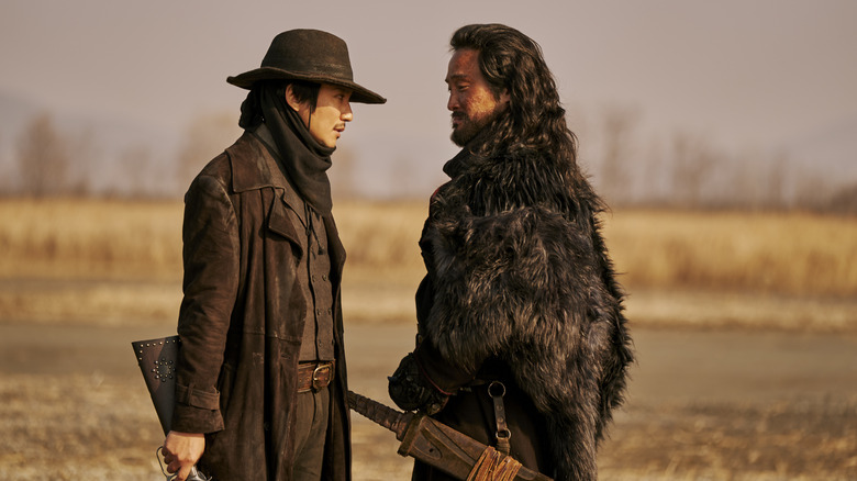 Lee Yoon (Kim Nam-Gil) habla con un bandido en la pradera en Song of the Bandits