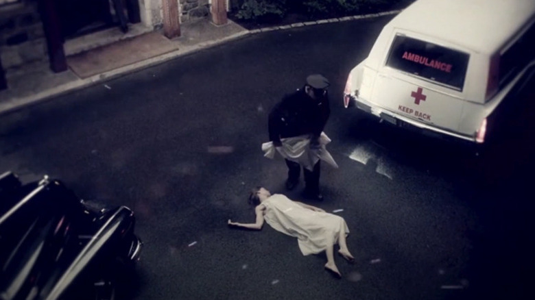 A woman lies dead on the street while an ambulance driver moves to cover her with a sheet in the opening credits of The Jinx