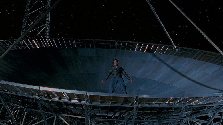 Jim Carrey stands on a massive satellite dish in The Cable Guy