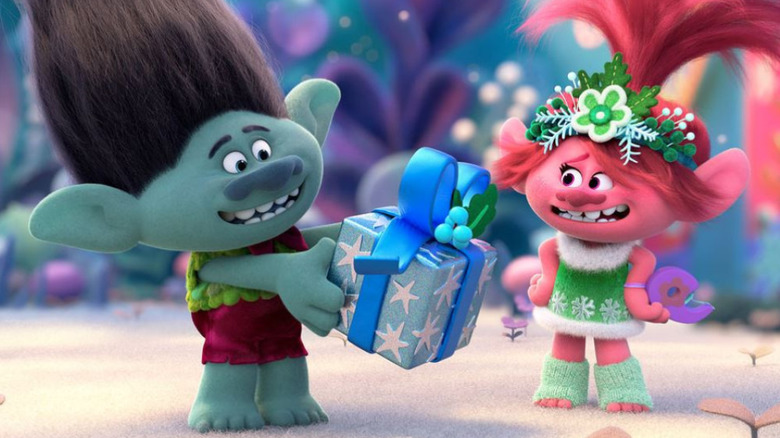 Branch (voiced by Justin Timberlake) holding a gift beside Poppy (voiced by Anna Kendrick)