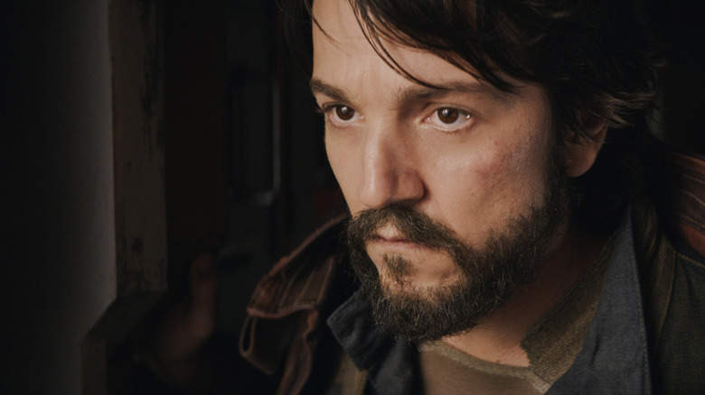 Diego Luna as Cassian looking grimly at something offscreen in Andor