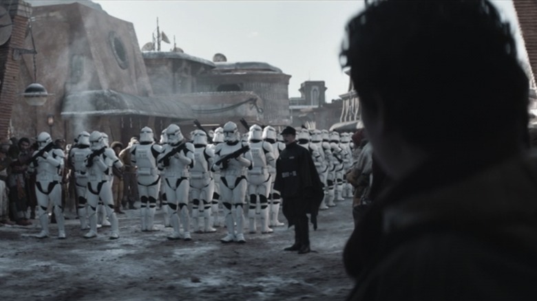 Young Cassian Andor watches a number of clone troopers at the beginning of what might be a massacre