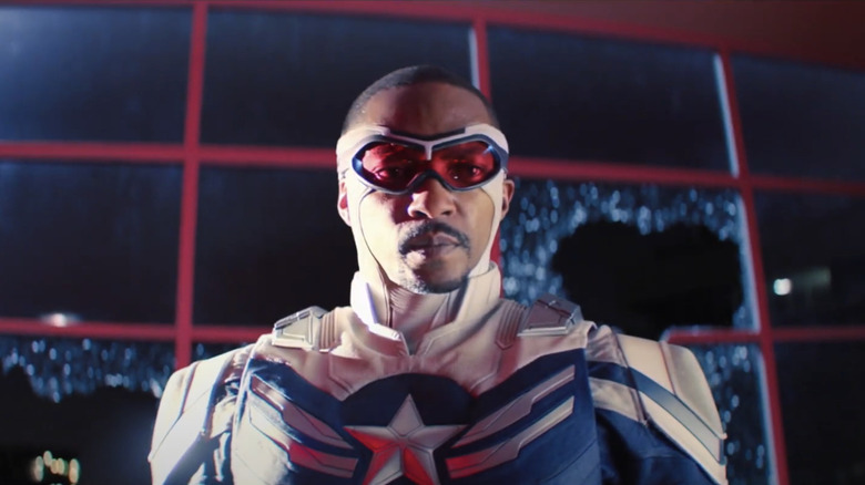 Anthony Mackie's Sam Wilson/Captain America looks ahead after smashing through a window in The Falcon and the Winter Soldier