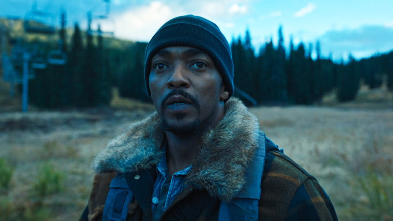 Anthony Mackie's Will stands in a field looking worried in Elevation