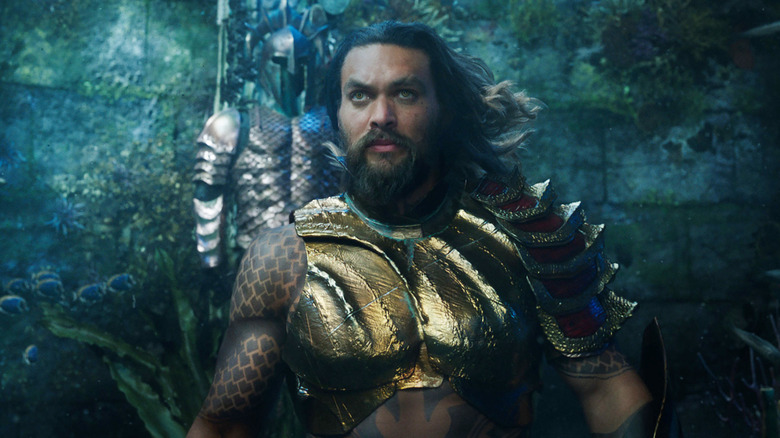 Jason Momoa as Arthur Curry under water in his partial armor in Aquaman