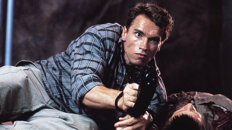 Arnold Schwarzenegger holding a gun in Total Recall