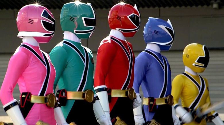 The main team standing together in their Power Rangers outfits from Mighty Morphin Power Rangers