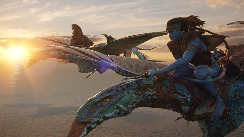 Sam Worthington as Jake Sully and Zoe Saldaña as Neytiri flying atop their winged steeds in Avatar: The Way of Water