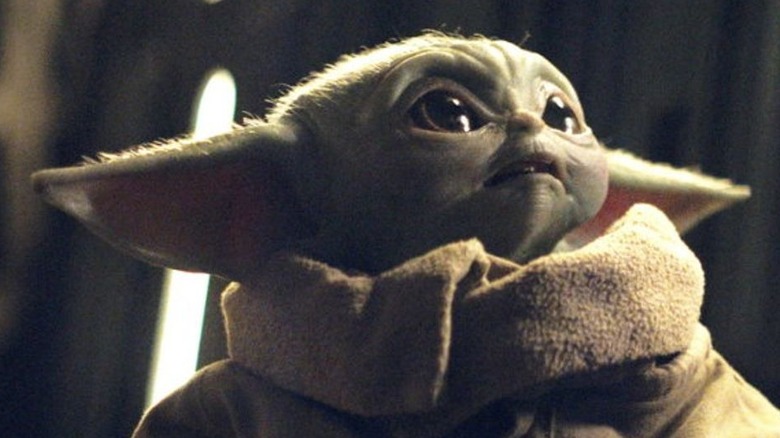 Baby Yoda looking up