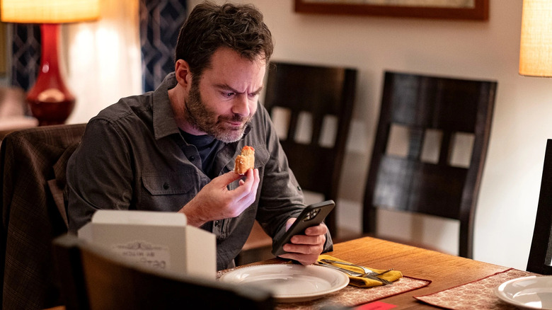 Barry eats at a table