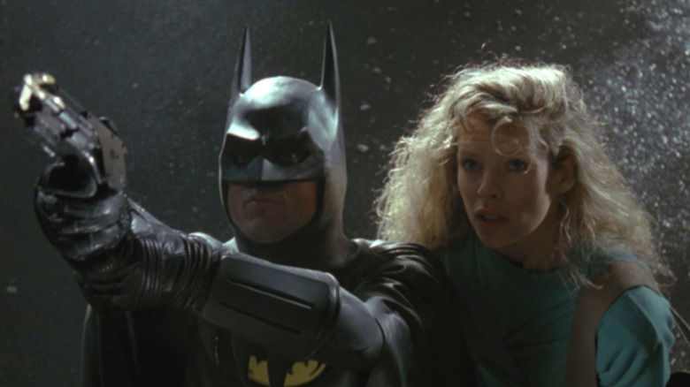 Batman and Vicki Vale aim gun