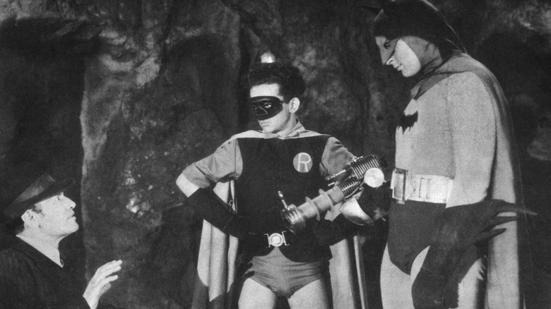 Batman and Robin interrogating a goon with a ray gun in the Batcave in Batman (1943)