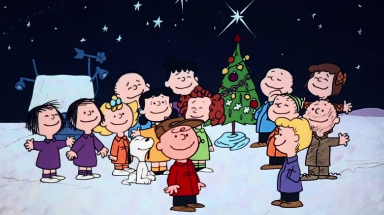 Charlie Brown Christmas' cast smiling near Christmas tree