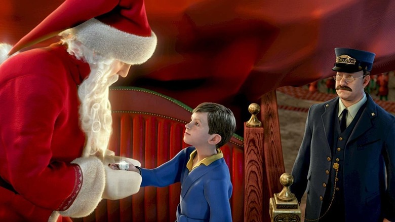 The Polar Express' Santa giving boy present near conductor