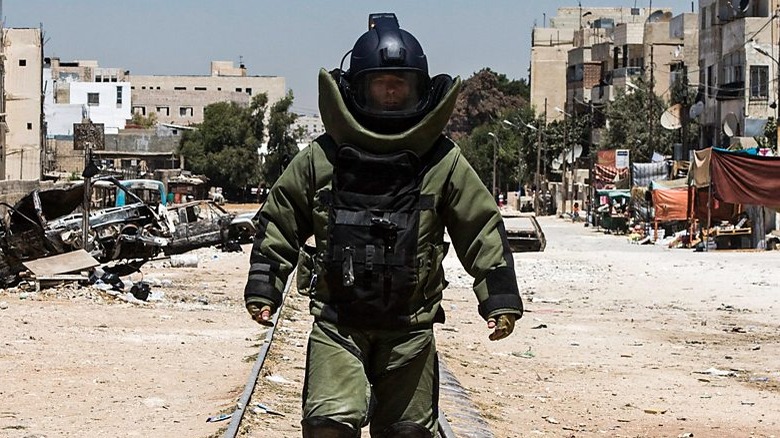 Sgt. James walking in bomb suit