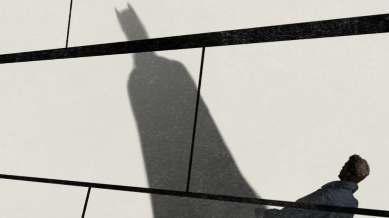 A man walks while Batman's shadow extends over the Batman & Bell documentary poster