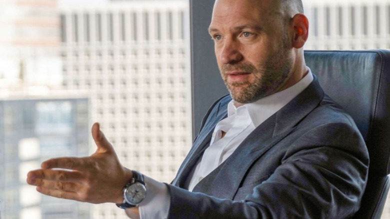 Corey Stoll gesturing at desk