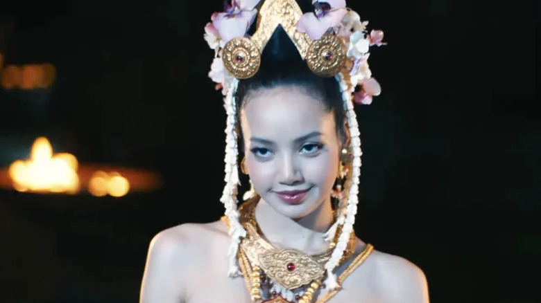 Mook wearing traditional Thai headdress performing on The White Lotus