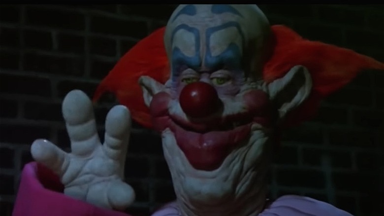 A killer klown waving hand