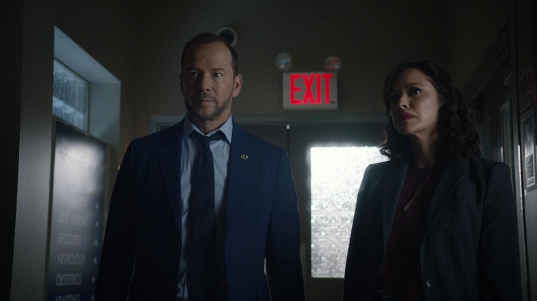 Donnie Wahlberg as Danny Reagan standing in a hallway with Marisa Ramirez's Maria Baez in the Blue Bloods episode Hate is Hate