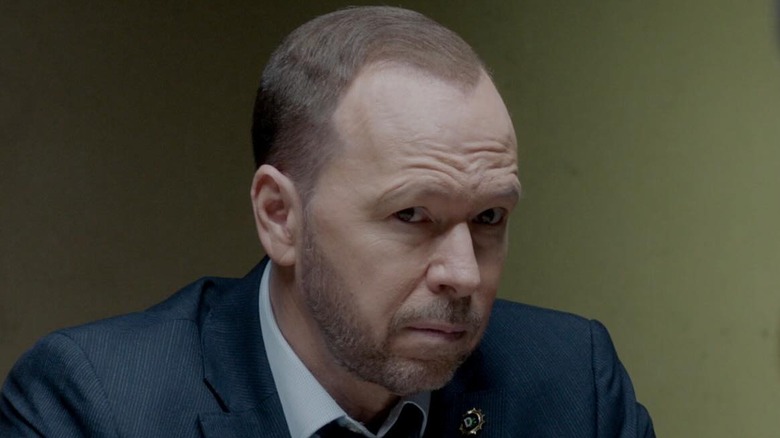 Donnie Wahlberg as Danny Reagan sitting at an interrogation table in Blue Bloods