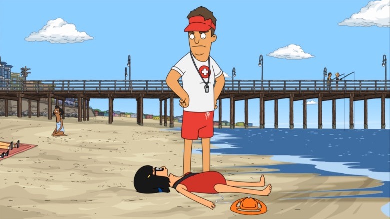 Coach looks at Tina on the beach