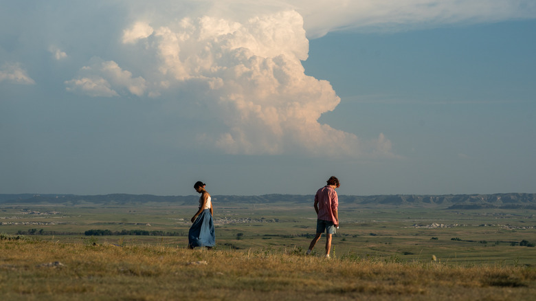 Taylor Russell and Timothée Chalamet on a hill in Bones & All