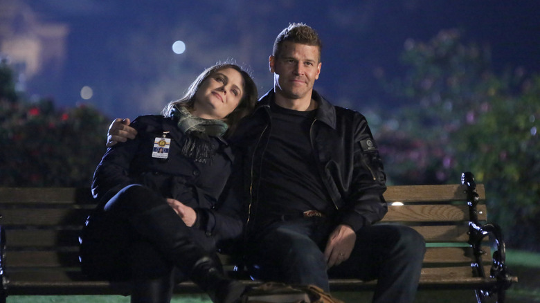 Emily Deschanel's Temperance Brennan and David Boreanaz's Seeley Booth sitting on a bench on Bones