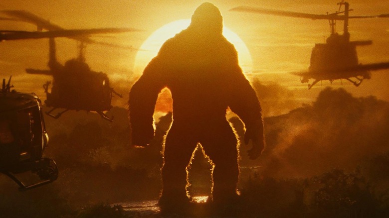 Kong standing tall as helicopters fly toward him in Kong: Skull Island 