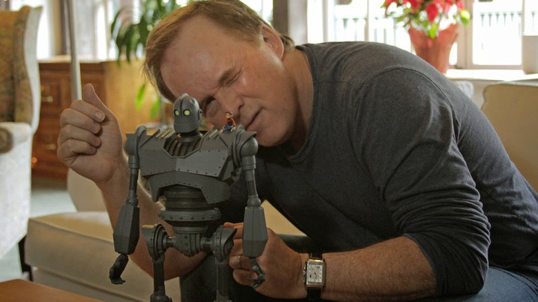 Brad Bird with an Iron Giant statue