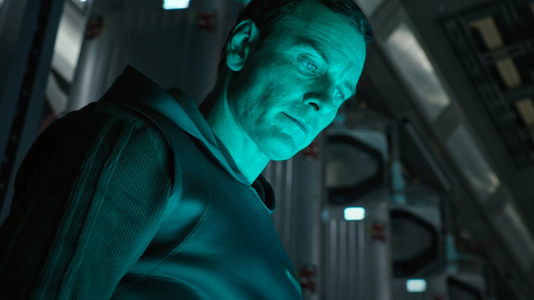 Walter looks at a green object in Alien: Covenant